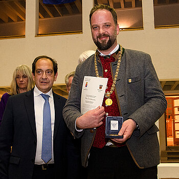 Bürgermeister Christan Béraud und OB Tobias Eschenbacher (v.l.), mit Urkunde und Stadtmedaille. (Foto: Stadt Freising)