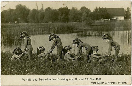 Acht als Frösche maskierte Turner auf den Ängern zwischen Anger- und Gartenstraße (Stadtarchiv Freising, Postkartensammlung).