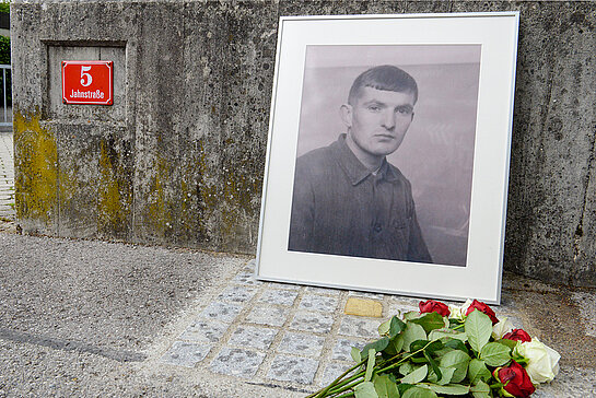 Während der Gedenkveranstaltung an der Jahnstraße 5 wurde der neue Stolperstein mit einer historischen Aufnahme von Johann Rannertshauser und Blumen dekoriert. (Foto: Stadt Freising)