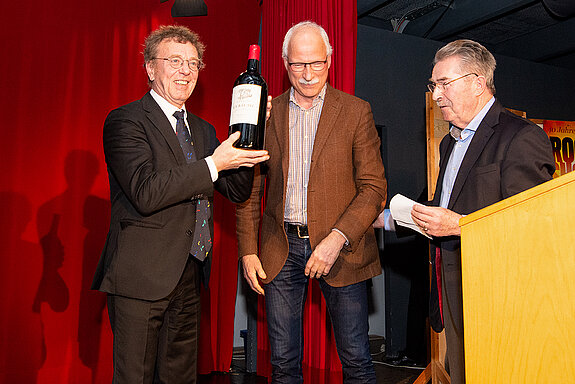 Vorfreude auf den guten Tropfen: Martin Keeser mit der Riesenflasche Rotwein, überreicht von Jürgen Maguhn (Mitte) und Kulturreferent Hubert Hierl. 