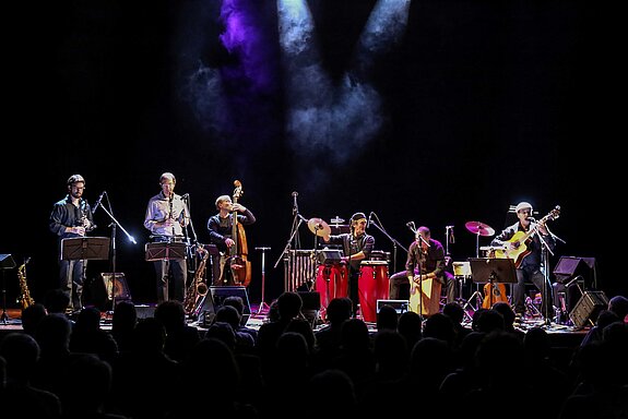 Musiker im Scheinwerferlicht auf eine dunklen Bühne