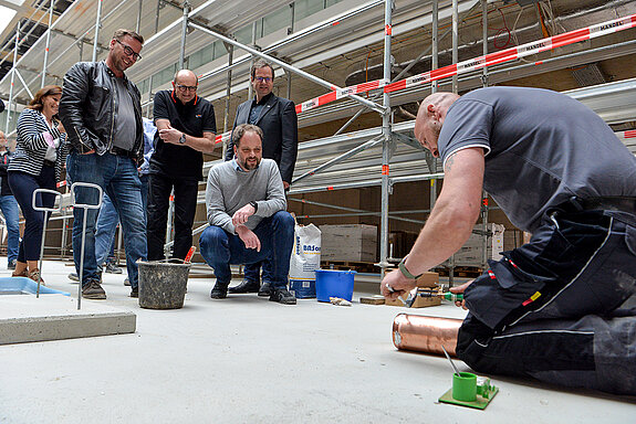 Sorgsam verlötet Bernd Martini, ein Mitarbeiter der Firma Dach Schneider (Dachabdichtungs- und Spenglerarbeiten), das kupferne Rohr. (Foto: Stadt Freising)